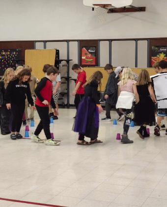 4th - 6th graders playing a round of ‘musical cups’ while waiting for the timer for the escape room puzzles to start.
