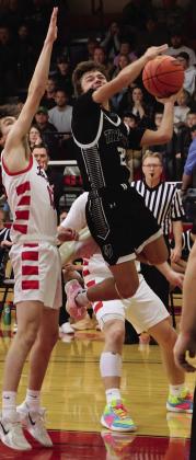 Trenten Keena tries to shoot through two North Star defenders.