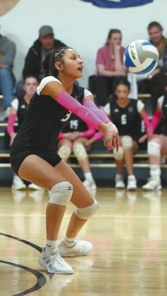 Senior Raelyn Knutson prepares to hit the ball during play against North Border. Photo by Larry Stokke.