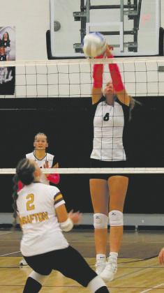 Peyton Larson leaps for the block, sending it back to the Spoilers. Photo by Jamie Rarick.