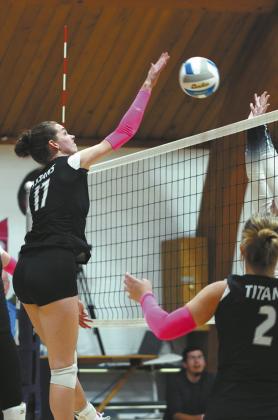 Elizabeth Fedje slams the ball over the net stunning her North Border opponent. Photo by Larry Stokke.