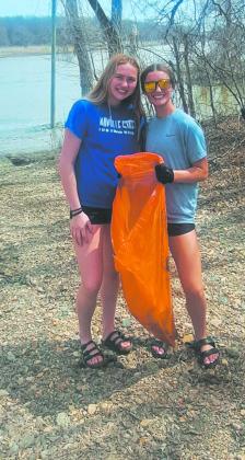 Students pick up trash along the boat launch on the Red River. Photo by Christine Jensen
