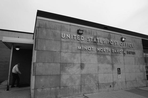 A resident enters the United States Post Office in Minot on Tuesday Oct. 25. Photo by Michael Standaert.