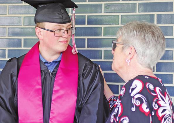 Cole Wilson and Mary Lou Feilen exchange greetings during the reception line following the graduation ceremony on Sunday afternoon. VNV Photo by Lesa Van Camp