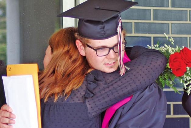 Siblings Ali and Nick VanCamp share a hug following the DHS graduation. VNV Photo by Lesa Van Camp