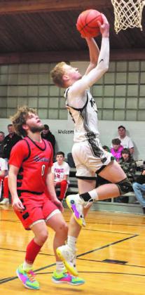 Connor Hurtt goes up on a two point attempt against North Star.