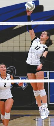 Brooke Gullickson watches as Elizabeth Fedje hits the ball over the net. Photo by Larry Stokke