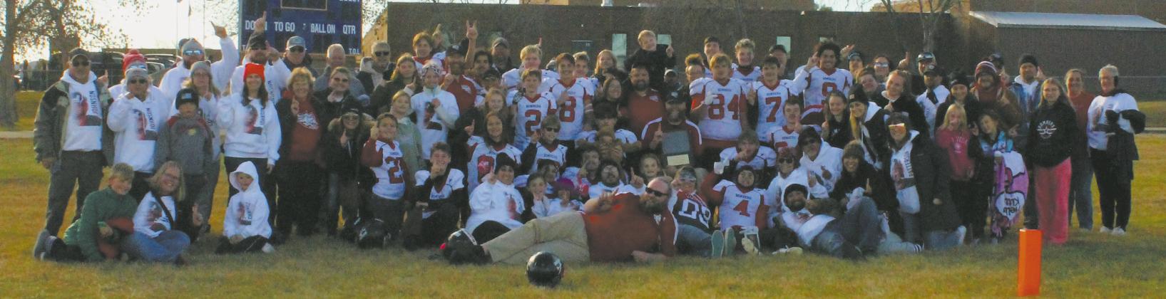 A supportive crowd of family and friends traveled to Trenton, N.D., for Saturday's 6-Man Football State Championship game and posed for a photo following the Bombers' victory. Photo by Candie Weyrauch.