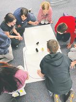 Students rally around with excitement for a “chicken race.” Photo submitted by Adam Riddle.