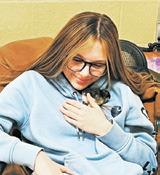Taylor Hermanson cuddles a newly hatched chick. Photo submitted by Adam Riddle.