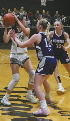 DVE senior Jaelyn Johnson looks to move the ball past North Prairie Defenders Payton DeMers and Ella Pederson. Photo by Jamie Rarick