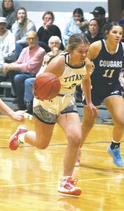 Trying to break loose from the Defenders with the ball, DVE senior Brooke Gullickson races down the court. Photo by Jamie Rarick