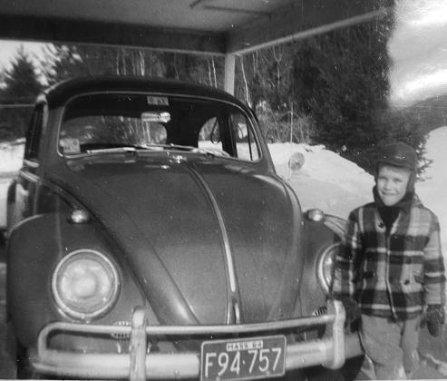 Young Ernie “Bob” Simmons posing with his fathers VW Bug. Submitted photo