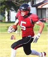Grant Vold carries the ball in action against P-NSP last Saturday. Photo by Lyle Van Camp.