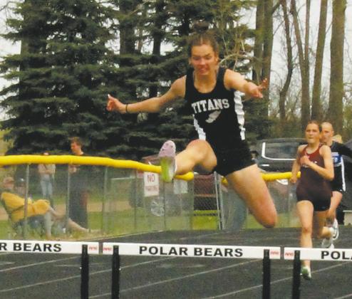 DVE teammates Jocelyn Vold and Elizabeth Fedje leap over the hurdles to a 2nd and 3rd place fi nish respectively, both moving on to the state competition in the womens 100m hurdles. Photo by Jamie Rarick