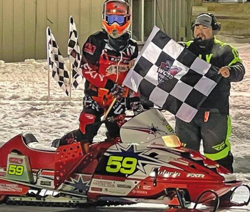Hunter Johnson poses with the flag at Eagle River. Photo submitted by Johnson Racing