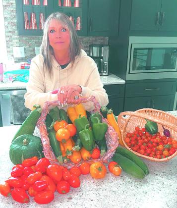 Top left: Treats made by Johnson come in many fun and intricate designs. Submitted photo Top right: LeeAnn Johnson, posing with only a very small portion of this year’s garden bounty. Photo by Christine Jensen