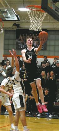 Jack Langerud takes to the air past defenders for the layup. Photo by Jamie Rarick