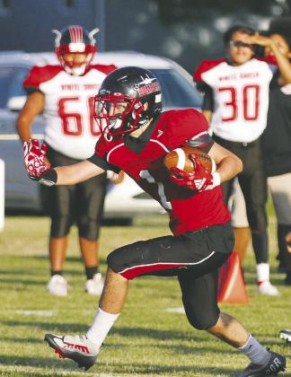 Freshman Trypp Castillo prepares to stiff-arm a would-be tackler in the third quarter of Saturday's game vs. White Shield. Photos by Mike Alan Steinfeldt.