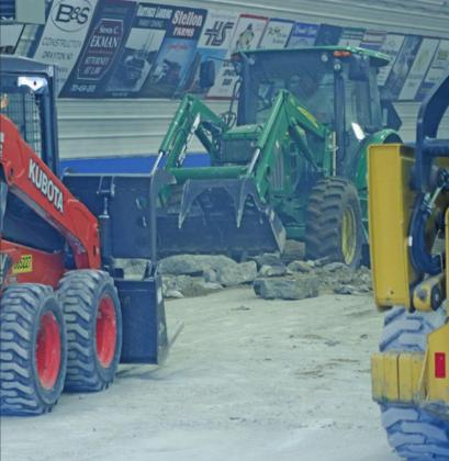 Boys just playing in their toys. Removing the old concrete floor from the Drayton Curling Club kicked up the dust and made quite a haze on a hot summer evening last week. VNV Photo by Lesa Van Camp