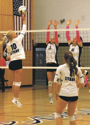Alyssa Hoyles and Ingrid Myrdal leap into the air in an attempt to block a Griggs Midkota hit. Photo by Jamie Rarick