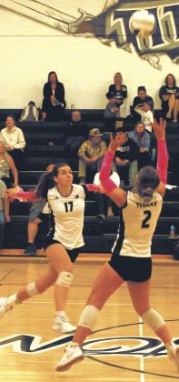 Brooke Gullickson sets the ball as Elizabeth Fedje moves in for the spike. Photo by Jamie Rarick