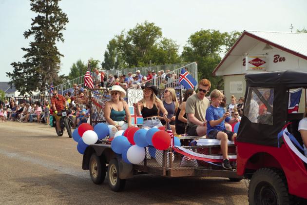 The Snorri Group, of which Julia Swanson was a part of, ride their float in the parade surrounded by massive crowds. Photo by Larry Stokke.