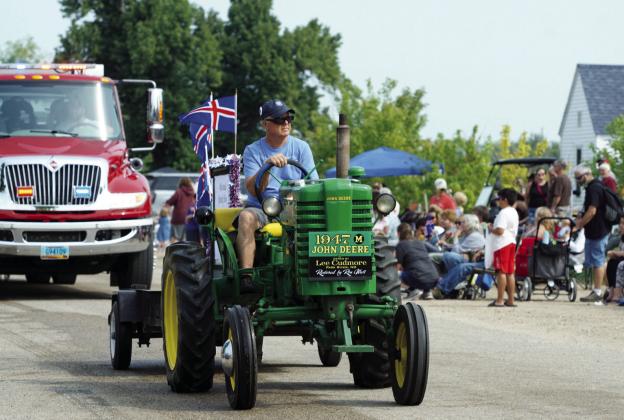 Lee Cudmore of Park River riding his 1947 restored John Deere tractor in the parade on Saturday. Photo by Larry Stokke.