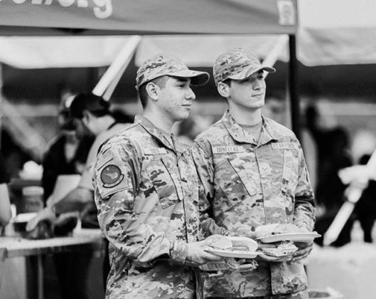 Military personnel enjoy their beef meal.