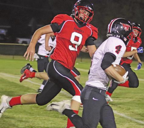 Damian Pokrzywinski tries to catch and stop Mustang Austing Almen from scoring last Friday night on the Drayton field. VNV Photo by Lesa Van Camp