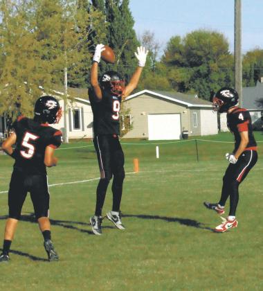 Lucas De Souza and Trypp Castillo celebrate with Mason Pollestad following Pollestad's impressive touchdown. Photo by Jamie Rarick
