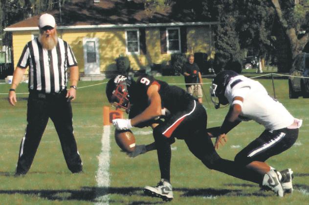 Recovering a Braves fumble, Mason Pollestad runs in for a Bomber touchdown. Photo by Jamie Rarick.