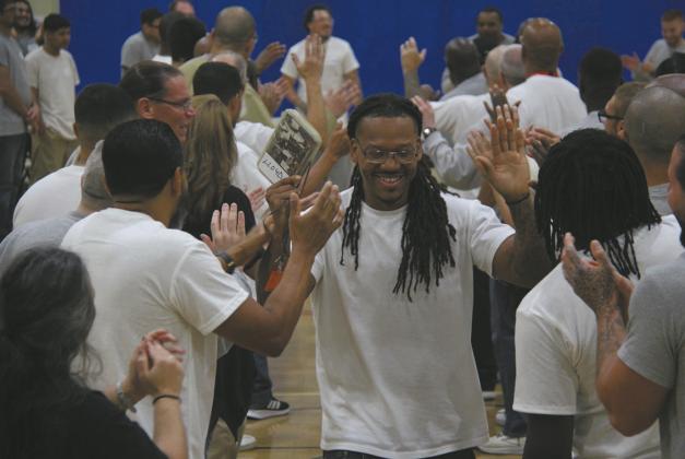 At North Dakota State Penitentiary, Shining Light Academy graduates run the 'gauntlet' — a tunnel of high-fives from fellow residents honoring the courage, growth, and commitment it takes to complete a program designed to help them thrive inside and succeed beyond these walls. Photo provided by Shining Light.