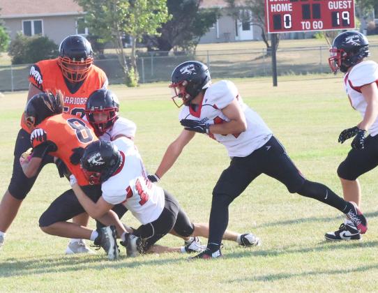 Bomber defenders Carter Johnson and Shawn Patterson bring down Warriors’ quarterback Brandon Black, Jr. Photo by Jamie Rarick