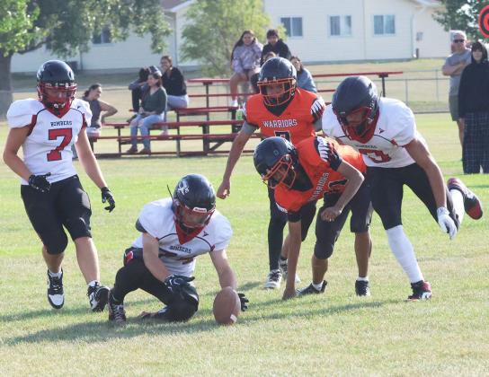 After Trenten Keena stripped the ball away from Warwick's Ryland Redfox, the fumble was recovered by teammate Praise Chairez. Photo by Jamie Rarick