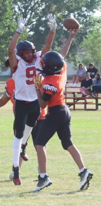 Leaping into the air, Bomber senior Mason Pollestad attempts to block the Warrior's QB.