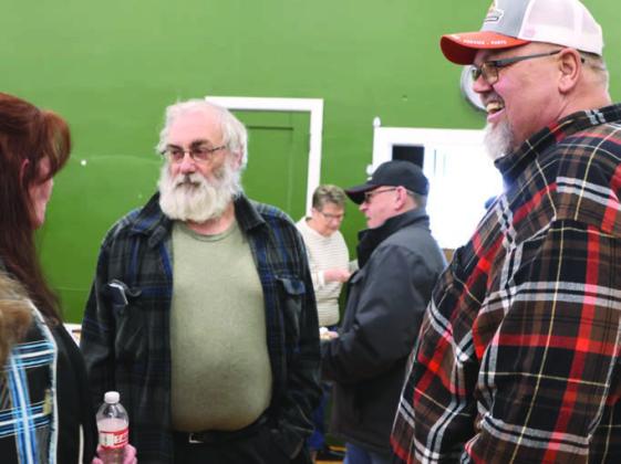 Lisa, left, and Don, right, Staskivige visit with a friend during the benefit Saturday.