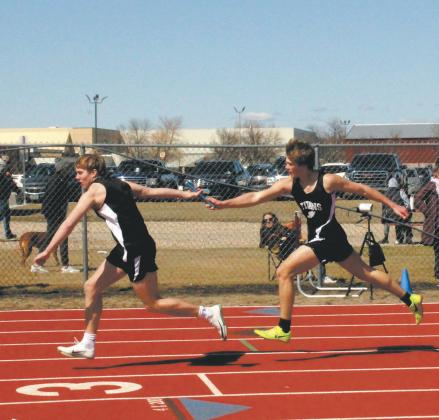 With a flawless handoff, Carter Oberg receives the baton from Sam Kittelson in the men’s 4 x 200 relay. The team placed 3rd, setting a new personal record for the event. Photo by Jamie Rarick