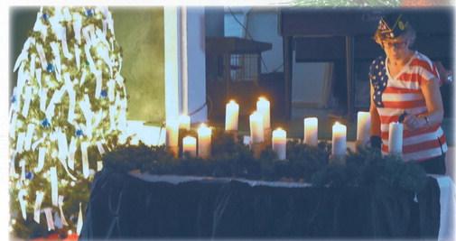 Kristi Scharmer lit the candles and read the names at the Tree of Lights service. Photo by Lyle Van Camp