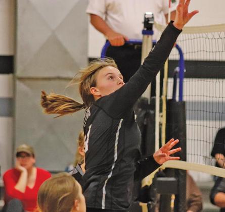 Aleah Pokrzywinski spikes the ball over the net in the matchup with Benson County. VNV photo by Lesa Van Camp