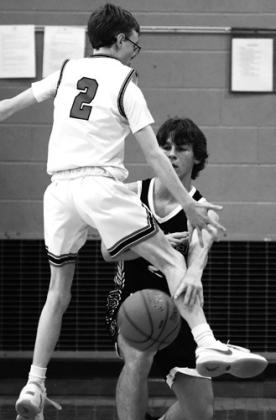 Logan Wieler makes a pass between the legs of Elijah Robinson. Photo by Lyle Van Camp.
