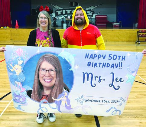 Mrs. Lee and DHS Athletic Director Raven Smith with her birthday banner. Photo courtesy of Drayton School.