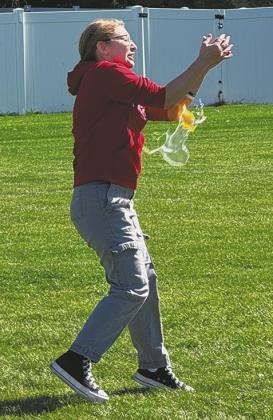 Kennedy Staskivige has her egg exploded in the fi nal round of the egg toss. She and Jonah Rarick fi nished second. Photo by Lyle Van Camp