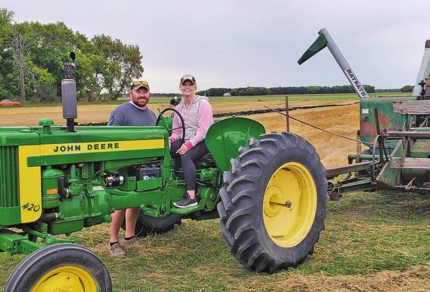 Kameron and Katie (Jensen) Dahl carry on the legacy of farming. Katie had the honor of taking the last round on Saturday afternoon. Photo by Kim Hemmes