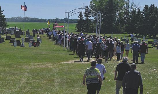 A procession through the cemetery followed the final mass held last Sunday. Reverend Schill discussed how the Our Lady Mt. Carmel Cemetery Fund is currently at $40,000, but needs to be closer to $100,000 to be a viable, lasting foundation. Photo by Hilary Nowatzki.