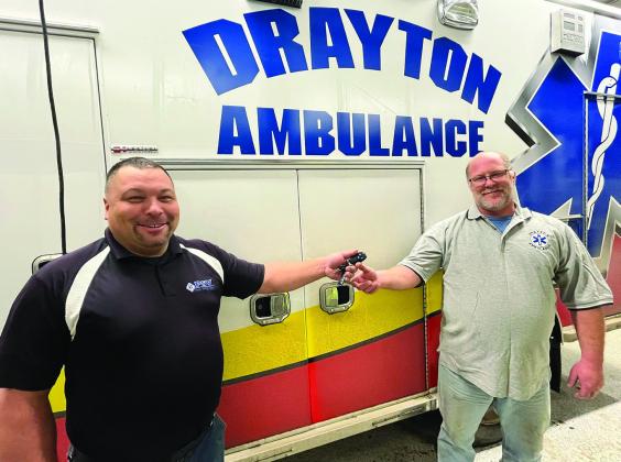 Premier Specialty Vehicles’ Mark Rethwisch hands the keys for the new ambulance to Drayton Ambulance driver Paul Larocque.