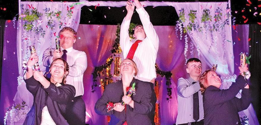 Time was taken out by these couples to set off confetti during the Prom Grand March on Saturday Night. Pictured left to right are: Hailey Berg and Bryce Wimpfheimer, Aleah Pokrzywinski and Ian Peterson, and Grant Vold and Claire Thompson. VNV Photo by Lesa Van Camp