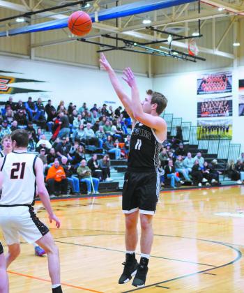 Issac Feltman sends the ball to the hoop in play against Cavalier. Photo by Larry Stokke