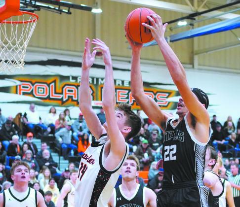 Tornadoes James Gagner attempts to block to the shot by Titans Mason Pollestad. Photo by Larry Stokke