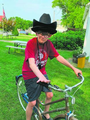 Dalton Boll delivering hats at the museum. Submitted photo